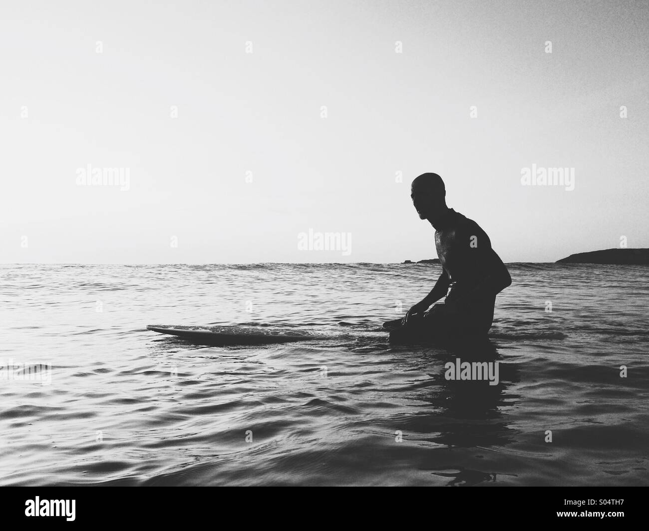 Surfer on surfboard waiting for waves. Stock Photo