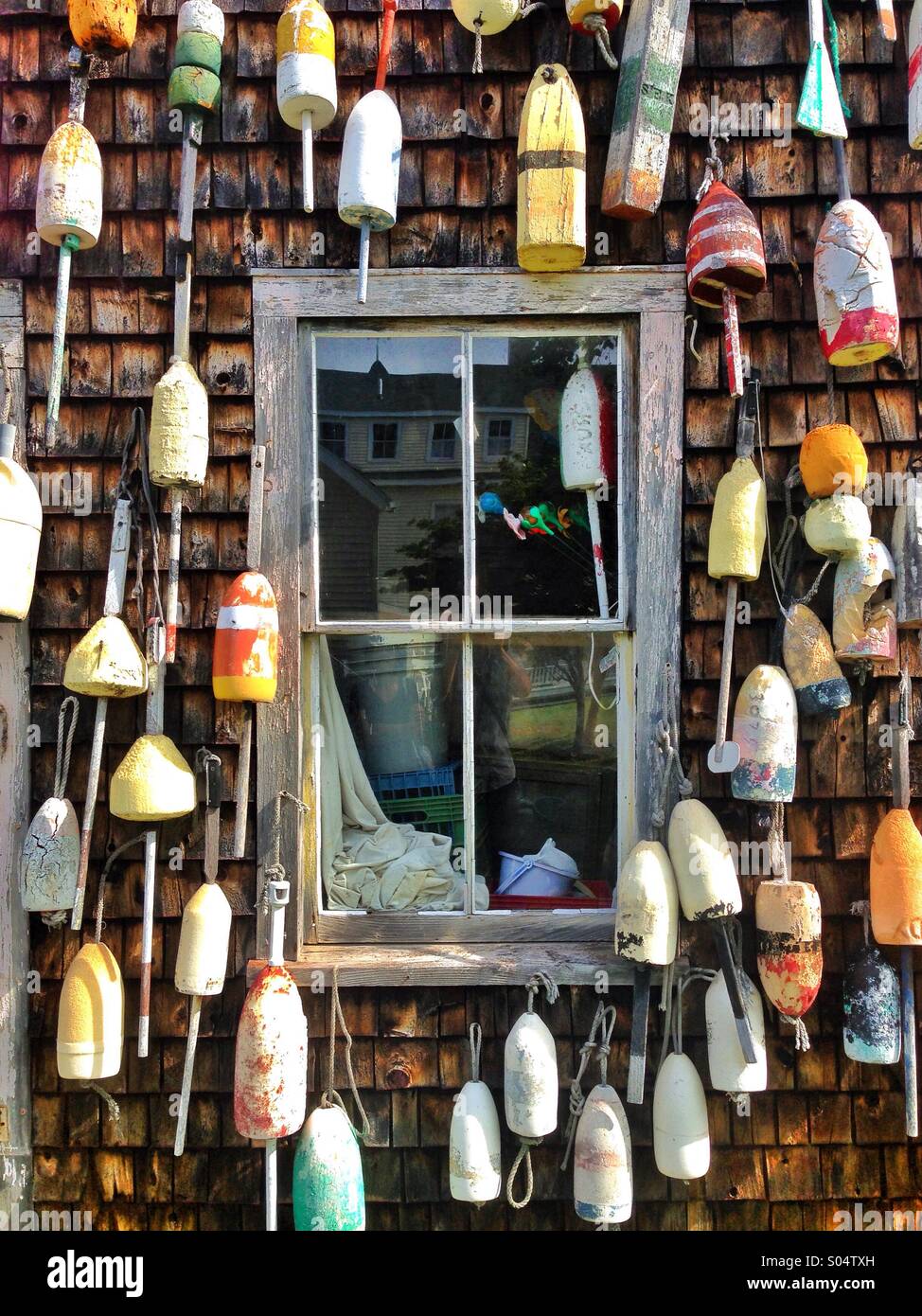 Old lobster buoys on building in Maine, USA Stock Photo - Alamy