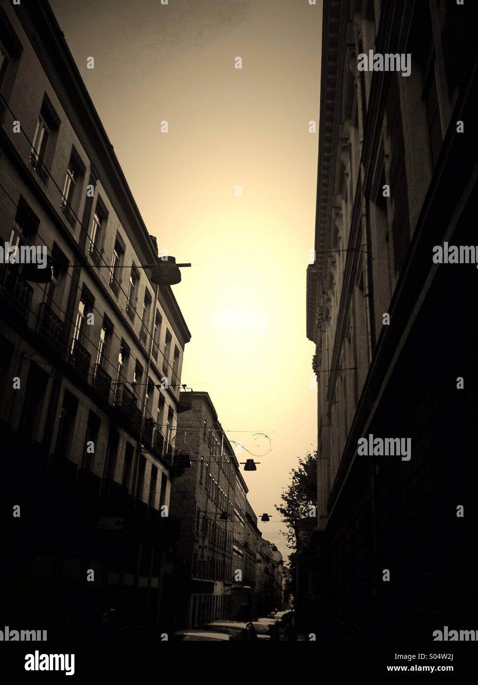 Sepia picture of the sky between two buildings, Saint-Etienne,France - Smartphone Captured Stock Image