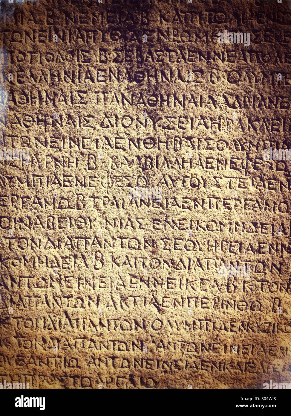 Ancient Greek inscription carved into stone. Delphi, Greece Stock Photo