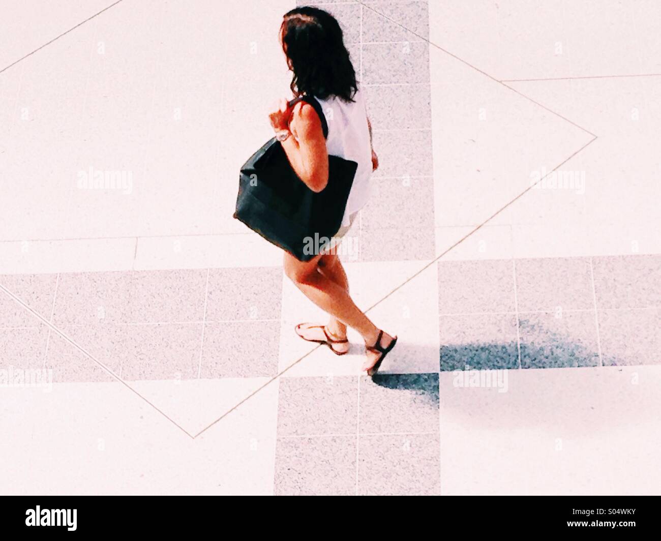 Woman walking across seen from above Stock Photo