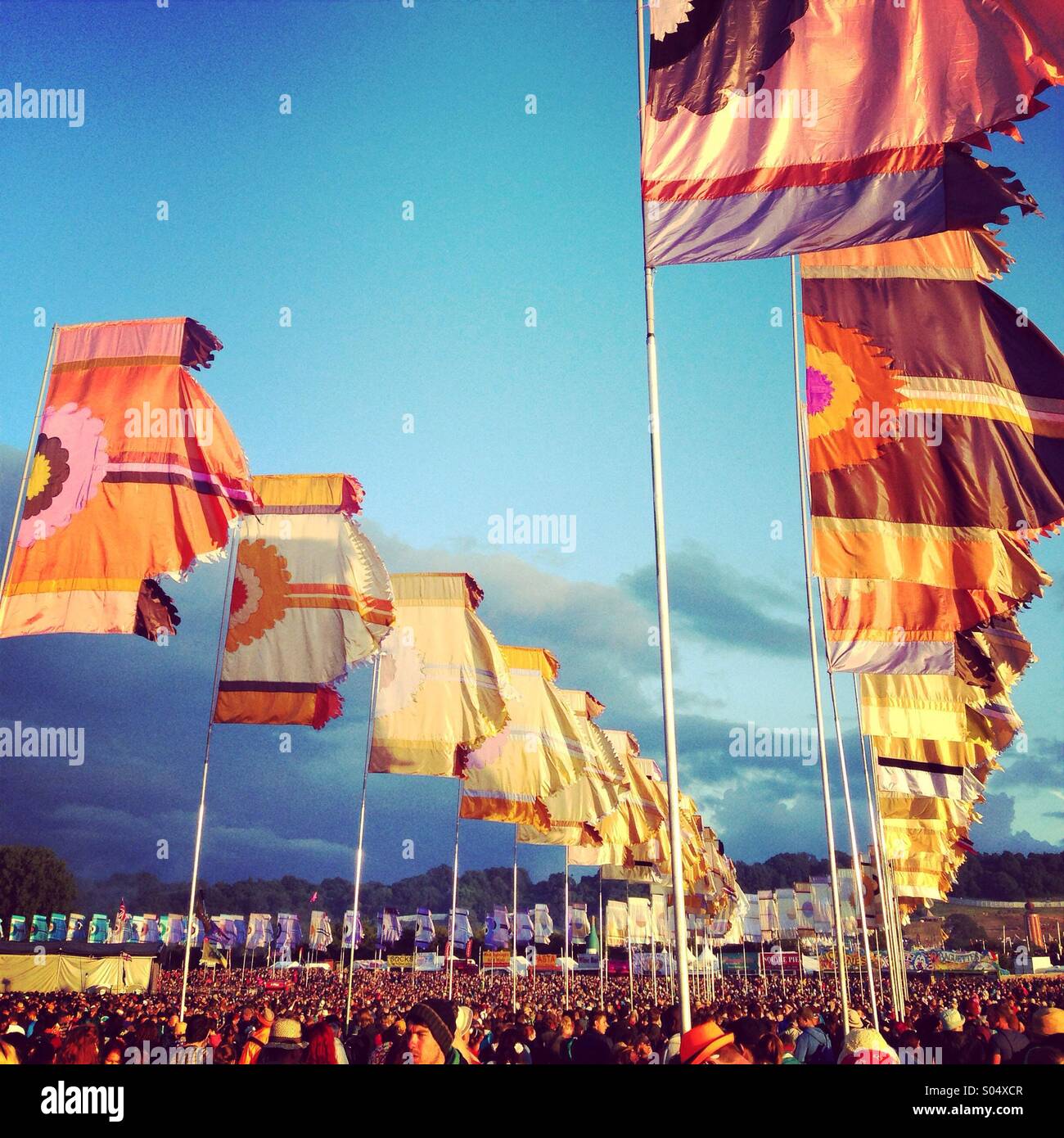 Crowd flags and atmosphere, golden hour, the other stage glastonbury festival 2014 - Smartphone Captured Stock Image