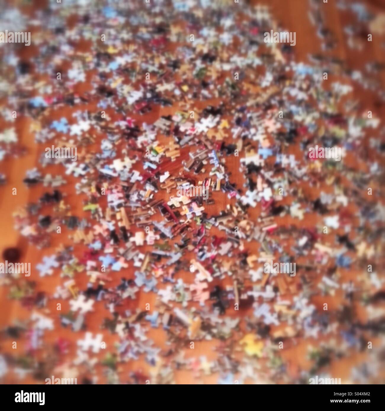 Confusion concept. Blurred jig- saw puzzle pieces spread out. Mobile phone photo with some phone or tablet post processing. - Smartphone Captured Stock Image