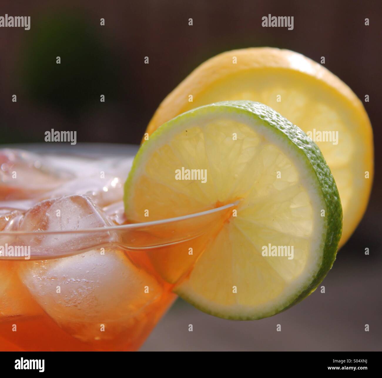 Iced drink with lemon and lime garnish Stock Photo Alamy