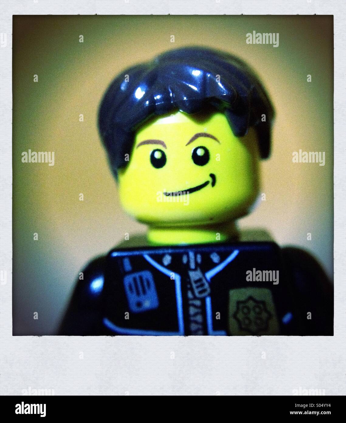 Lego figure portrait, male, black hair, smiling Stock Photo