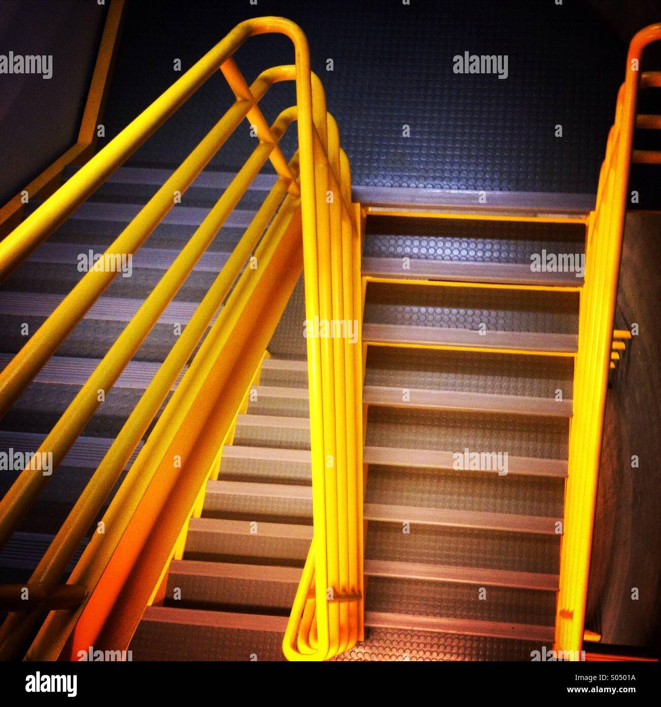 Industrial staircase in high tech office building. Going up, going down. Stock Photo