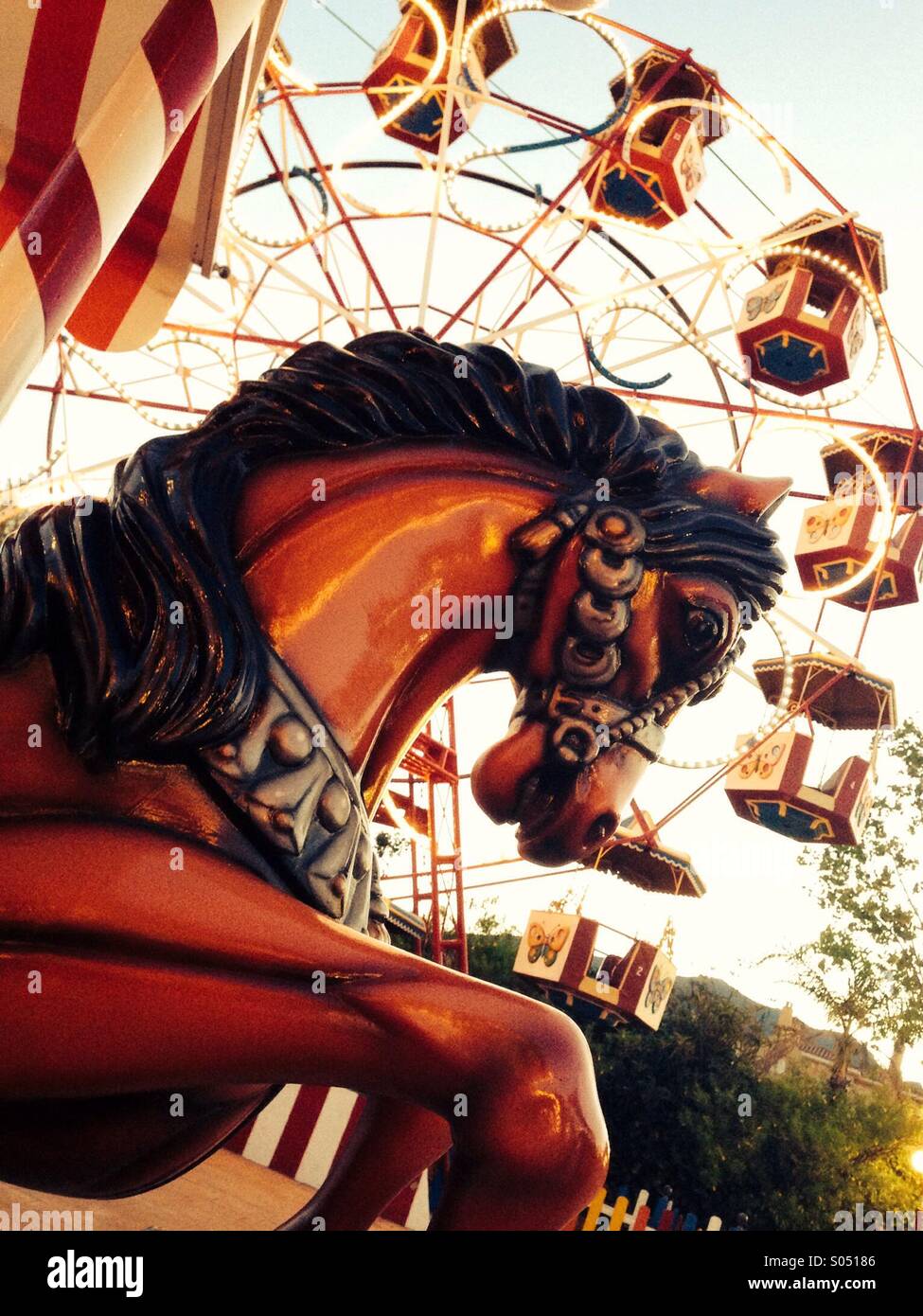 Merry-go-round horse in front of a big wheel - Smartphone Captured Stock Image