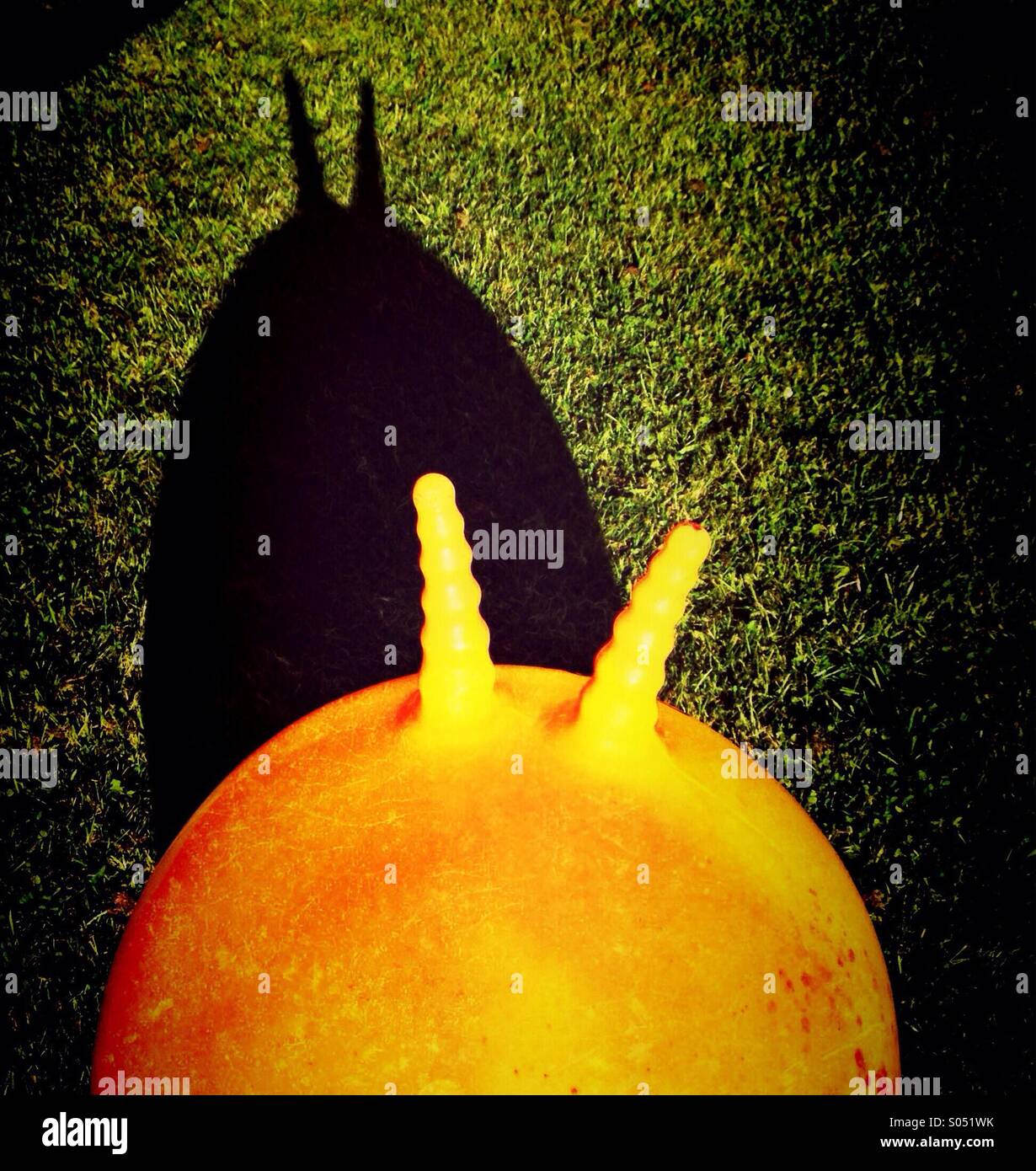 Space hopper casting long shadow Stock Photo