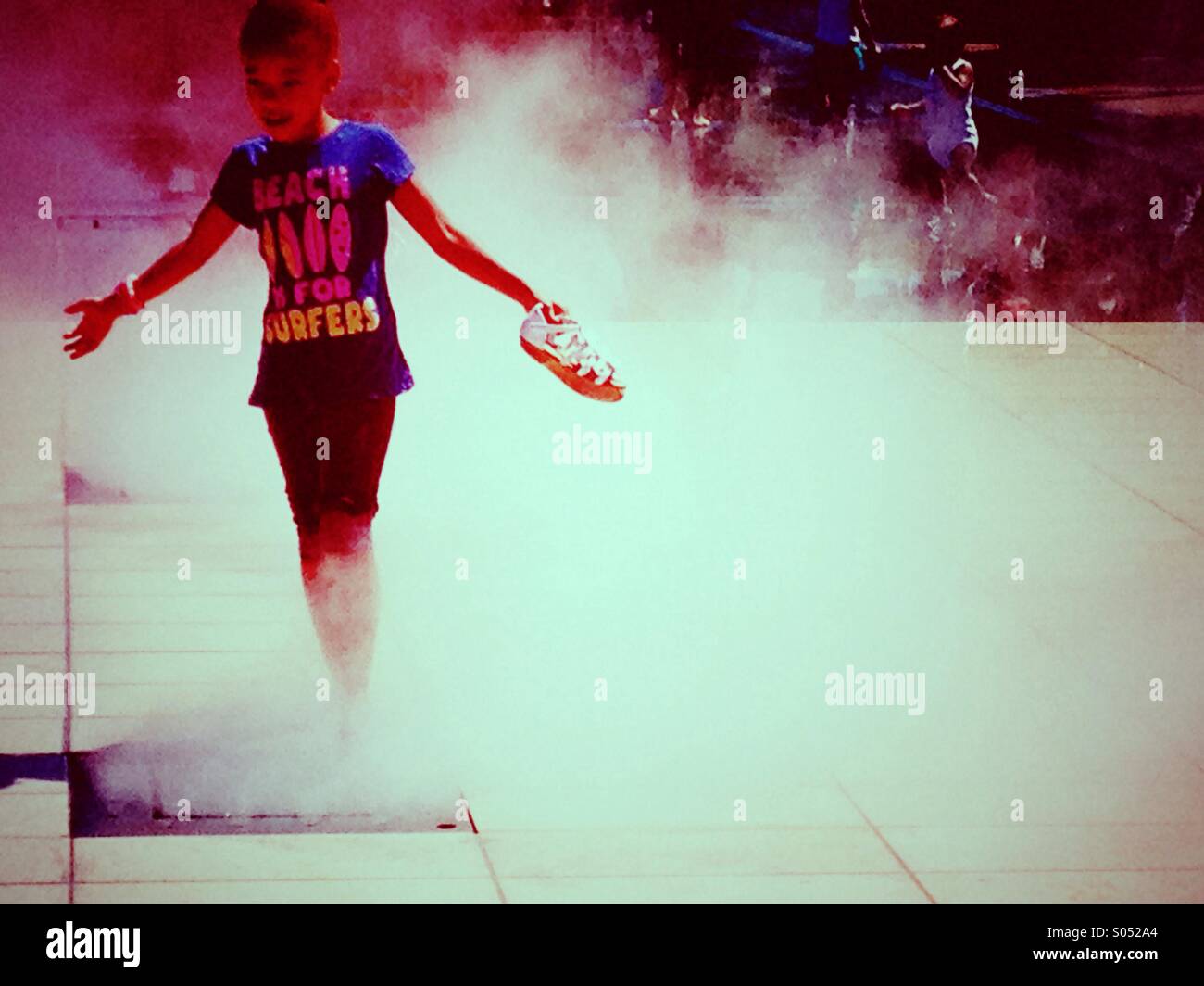 Young girl playing in a fountain Stock Photo - Alamy