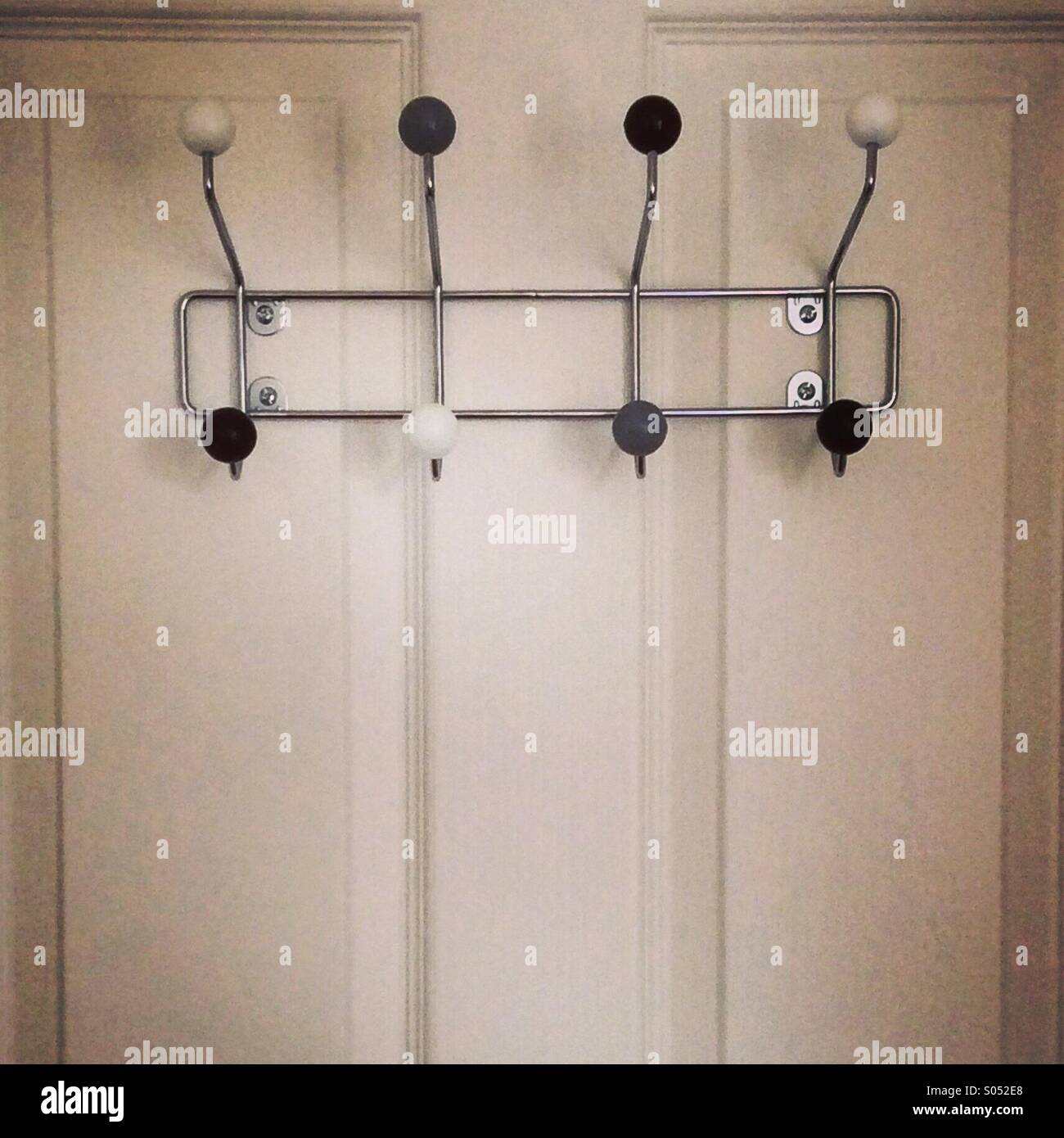 Retro 60s style coat hangers on a door. Instagram style iPhone mobile phone photo. - Smartphone Captured Stock Image