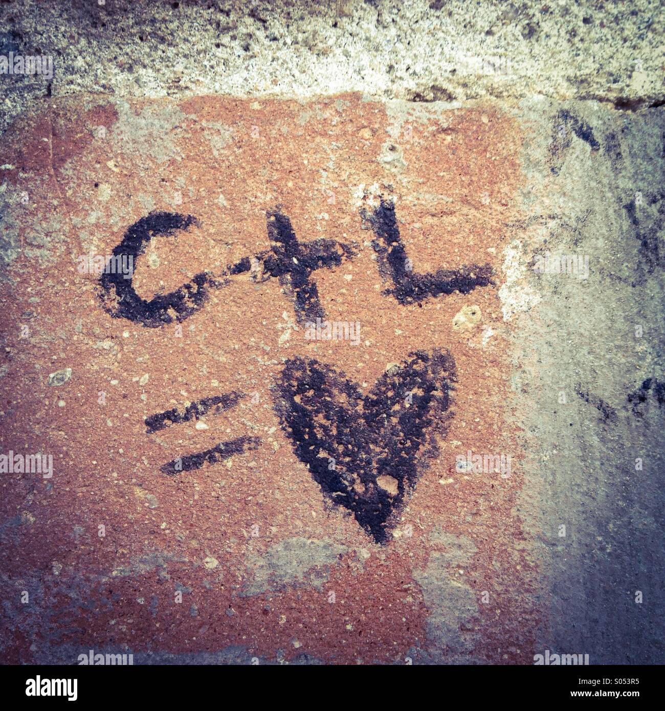 Graffiti on an urban wall professes love. Stock Photo