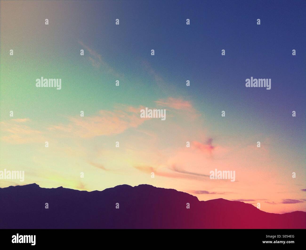 Red sky at night with some mountains in silhouette, Orba, Spain - Smartphone Captured Stock Image