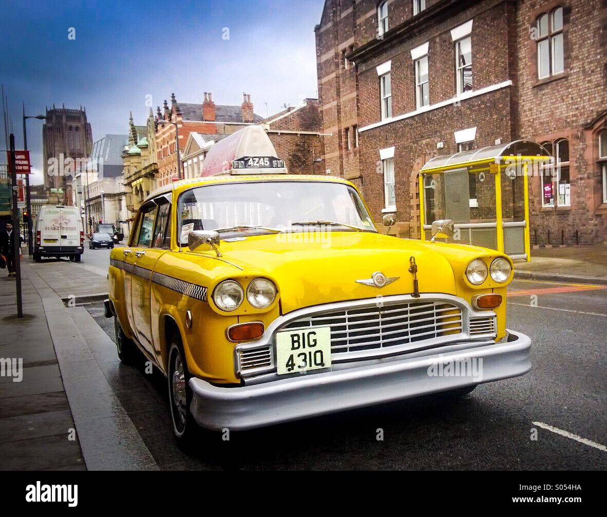 A yellow New York City cab parked up  in the heart of Liverpool UK Stock Photo