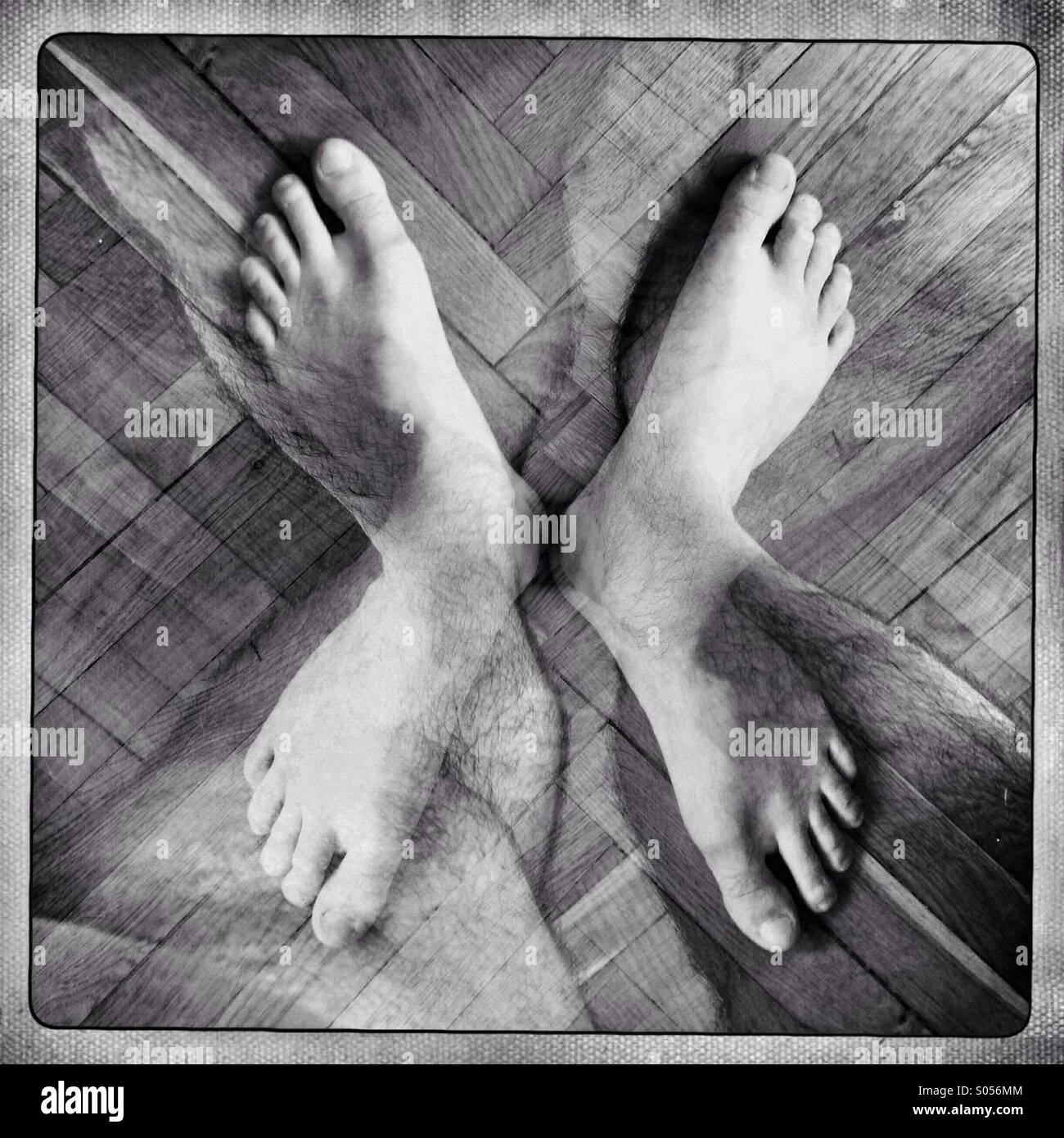 A pair of feet is seen in a double exposure. Stock Photo