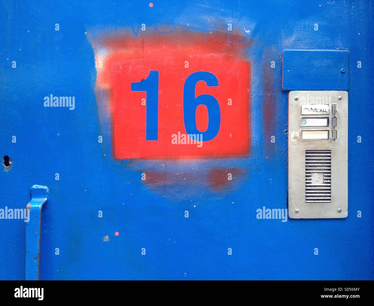 Stenciled number 16 on a door in Dublin city, Ireland. - Smartphone Captured Stock Image