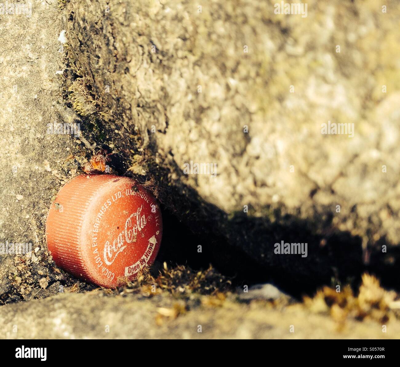 Close up of Coca Cola bottle top in wall - Smartphone Captured Stock Image
