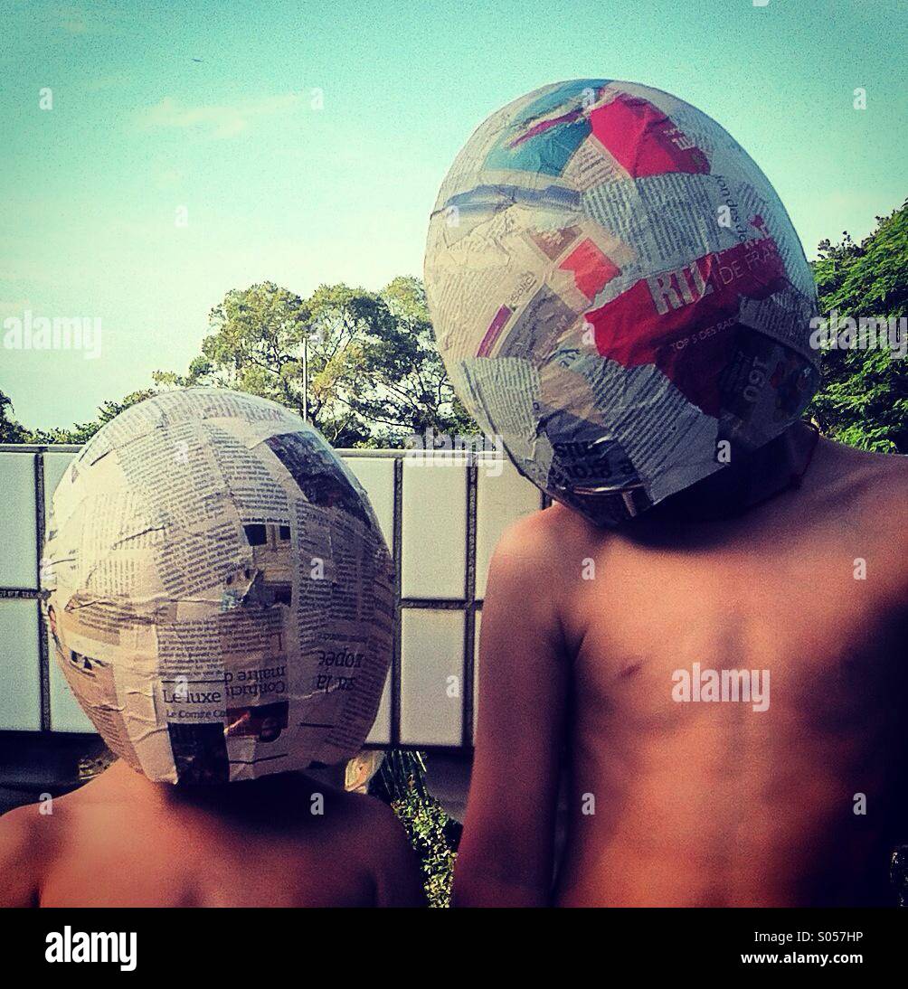 It's a photo of two kids with a full helmet made of newspaper... Like the Daft Punk band - Smartphone Captured Stock Image