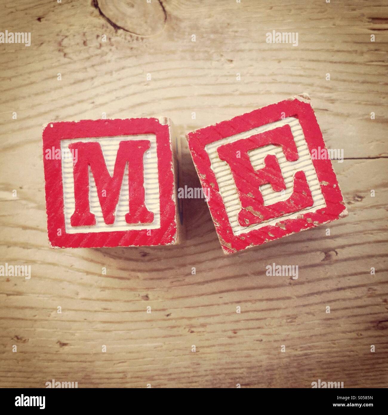 It's a photo of two wood cub put dide by side by a child to form the word: Me - Smartphone Captured Stock Image
