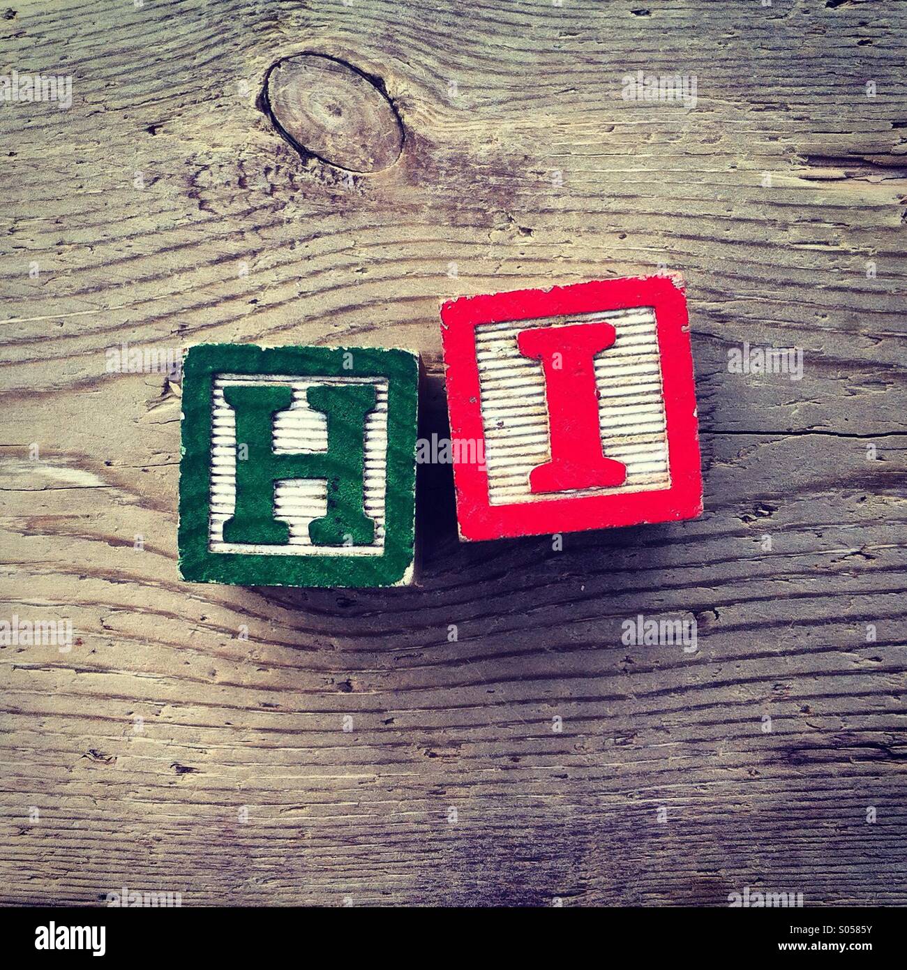 It's a photo of two wood cubes combined together by a child to create the word Hi - Smartphone Captured Stock Image