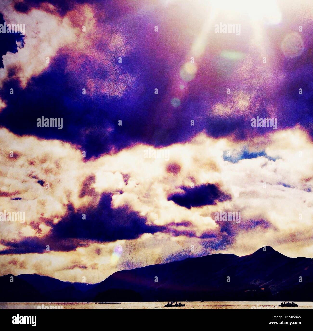 Rowing boats in silhouette on Derwent water in Lake District - Smartphone Captured Stock Image