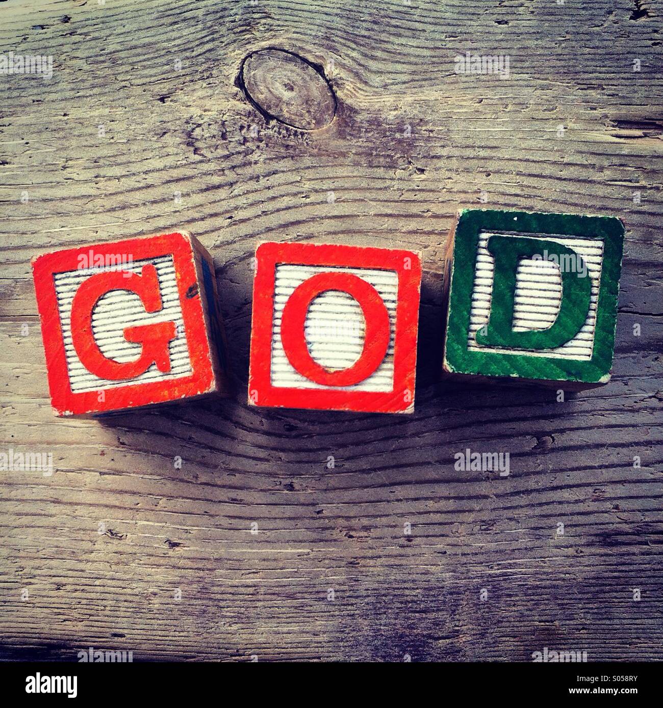 It's a photo of two wood cubes toy with letters that form the word GOD - Smartphone Captured Stock Image