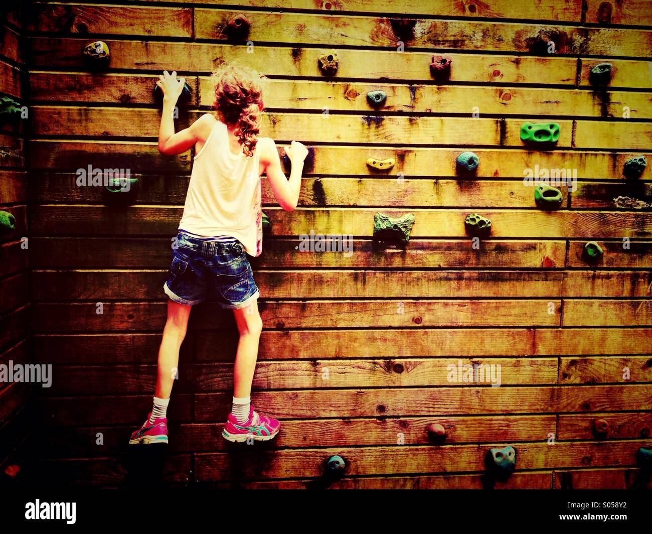 Girl on climbing wall Stock Photo Alamy
