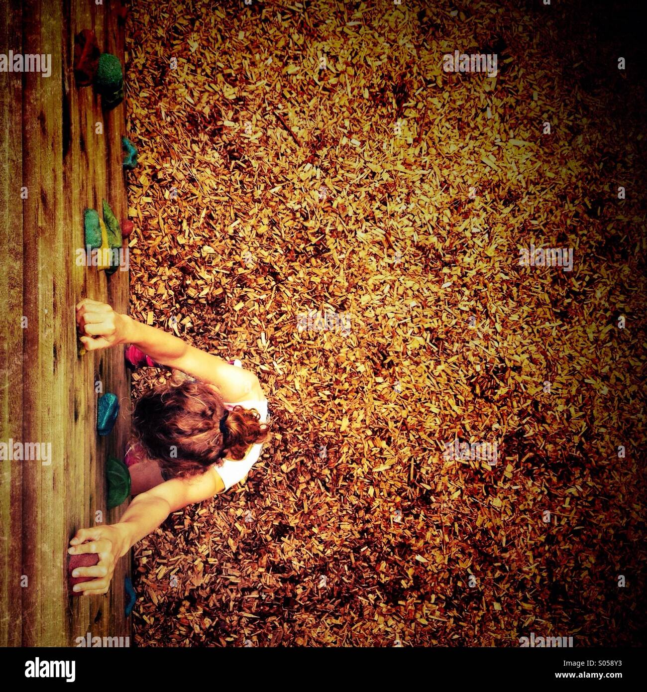 Looking down on girl on climbing wall - Smartphone Captured Stock Image