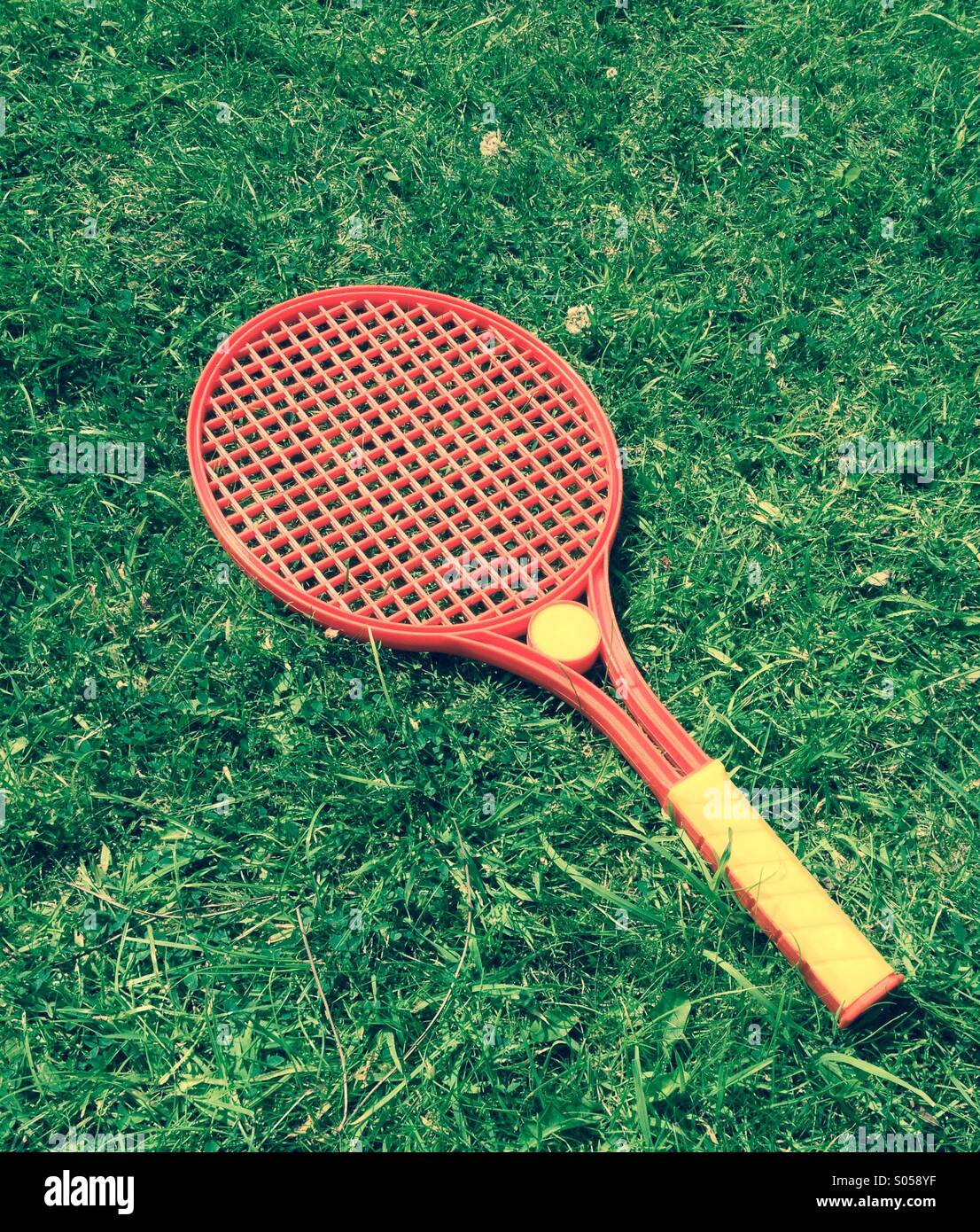 Tennis racket on lawn - Smartphone Captured Stock Image