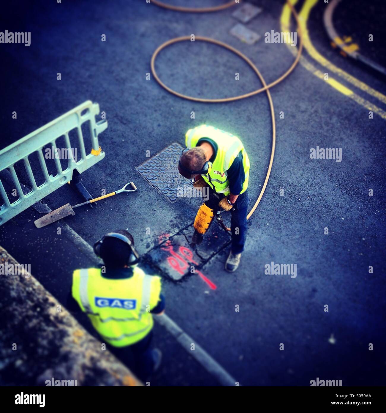 Gas board drilling up road for properties new Gas supply Stock Photo