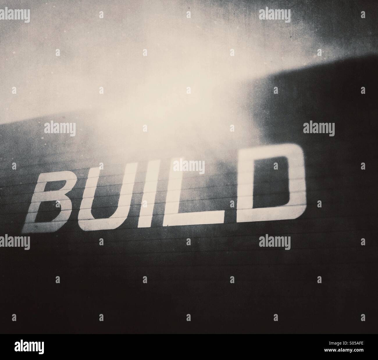 The word 'build' on side of wooden building. Stock Photo