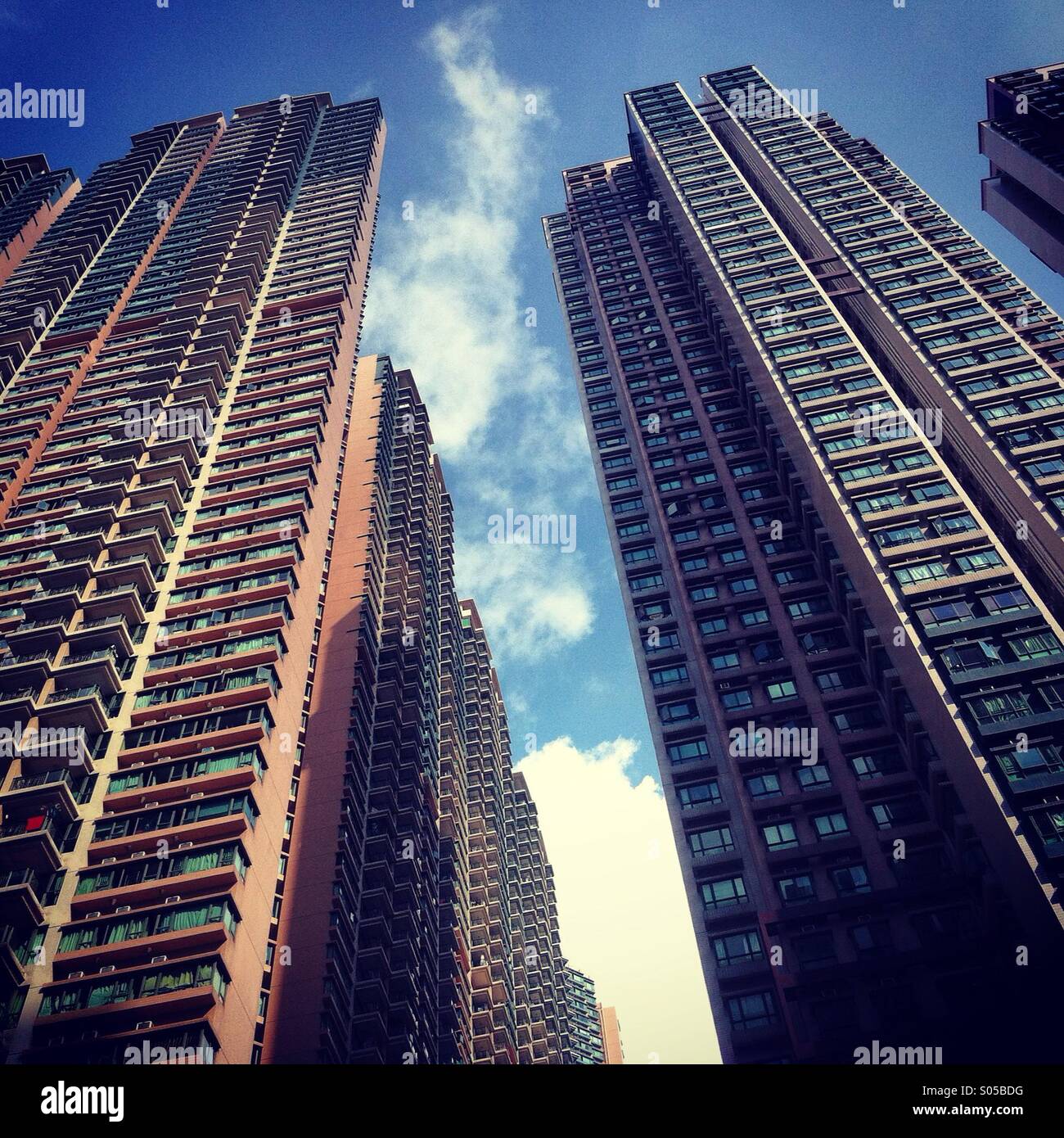 It's a photo of the tiny space whete you can see the sky in between a group of high towers in Hong Kong - Smartphone Captured Stock Image