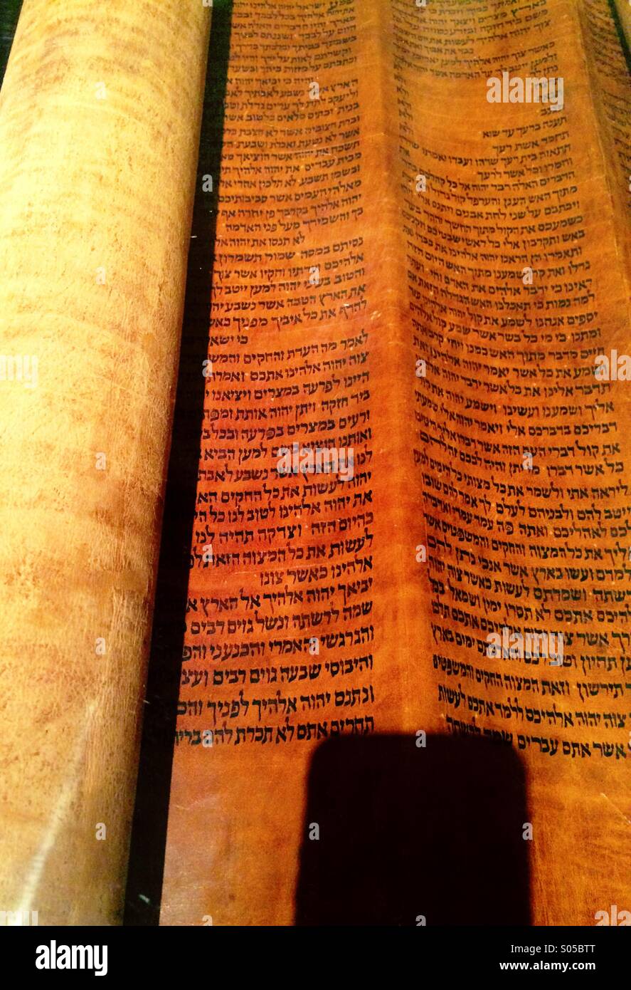 Shadow of a smart phone on the first printing of the Ten Commandments circa 1455 - Smartphone Captured Stock Image