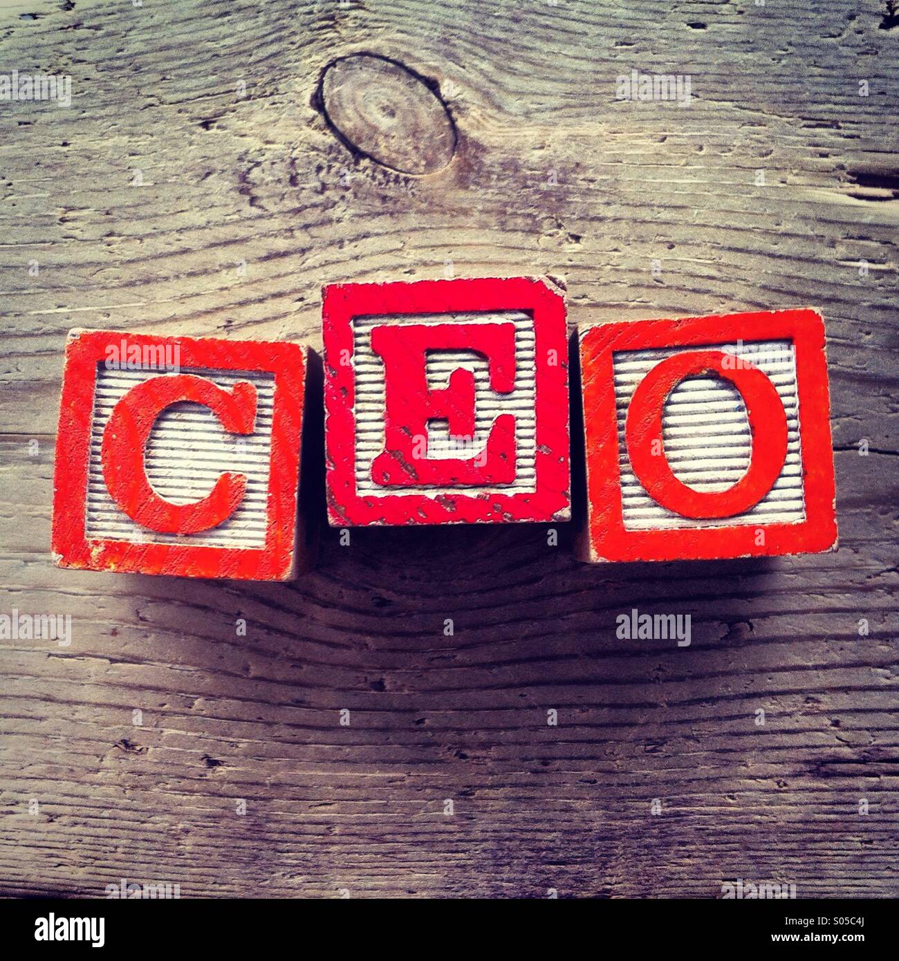 It's a photo of wood blocks toy with letters that form the acronym word CEO - Smartphone Captured Stock Image