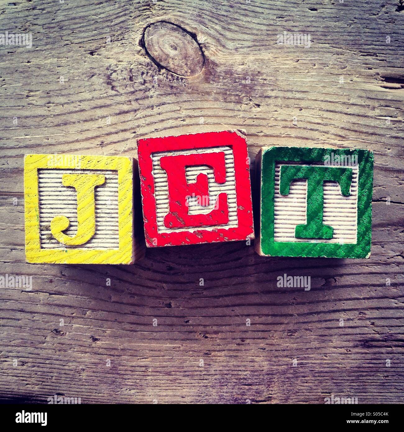 It's a photo of wood blocks toy with letters that form the word JET Stock Photo
