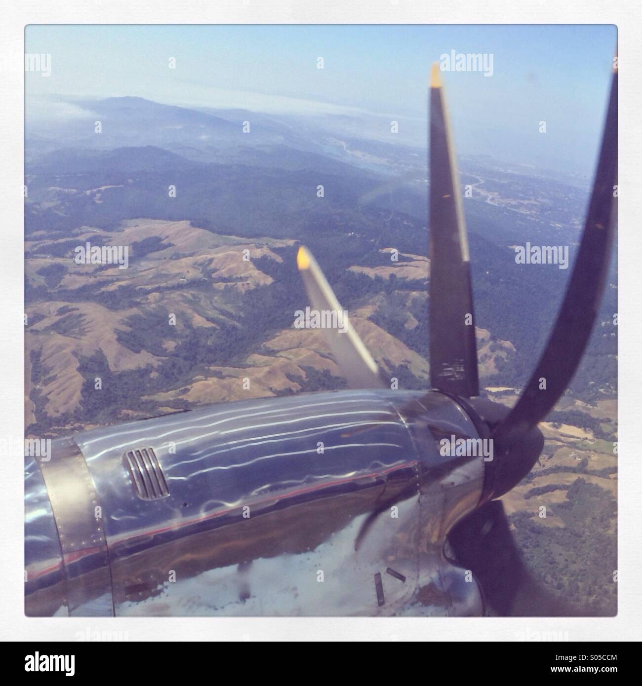 Prop plane over mountains - Smartphone Captured Stock Image