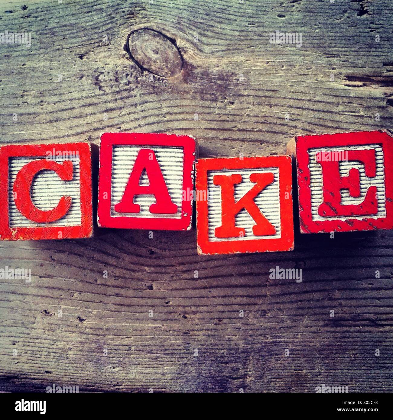 It's a photo of few wood blocks with alphabet letters combined together to create the word CAKE - Smartphone Captured Stock Image