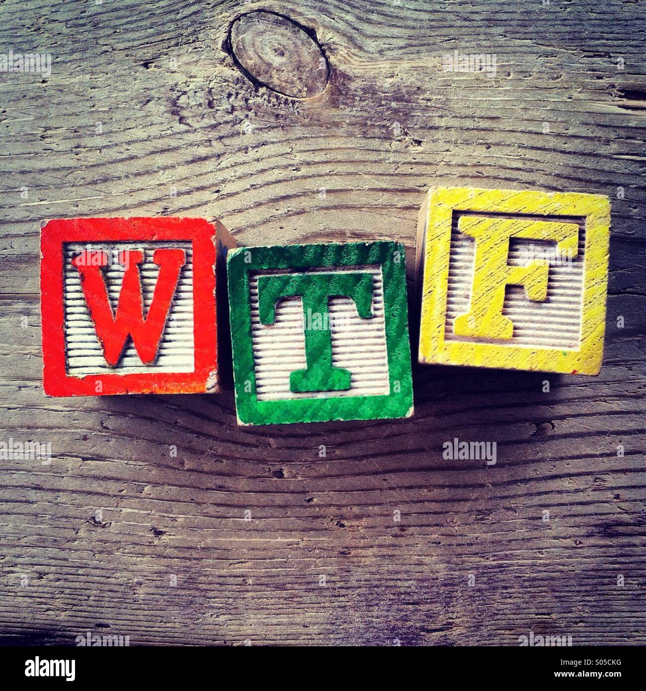 It's a photo of few wood blocks with colored letters on them that are combined together to create the acronym word WTF - Smartphone Captured Stock Image