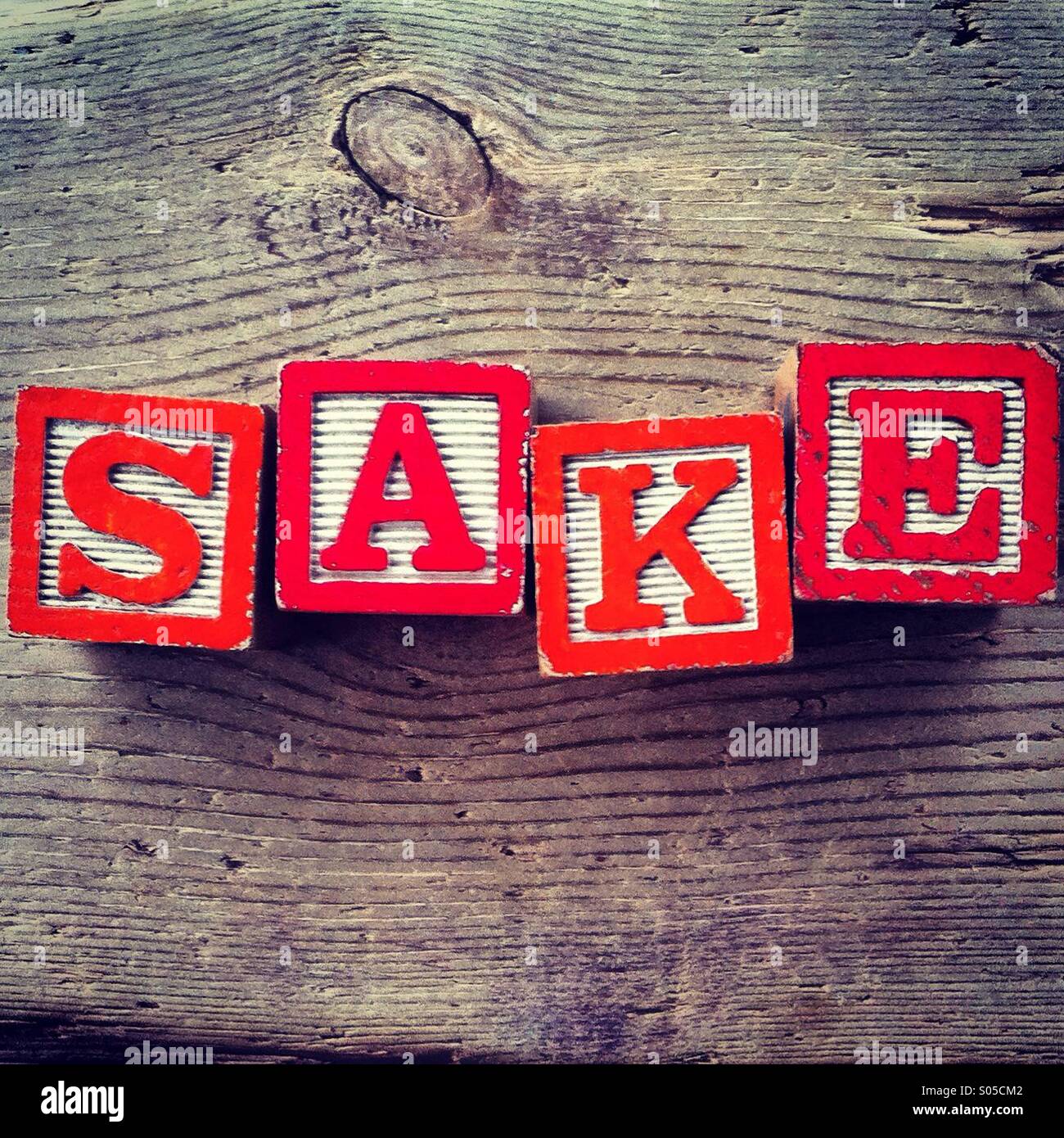 It's a photo of few wood blocks with colored letters on them that are combined together to create the word SAKE - Smartphone Captured Stock Image