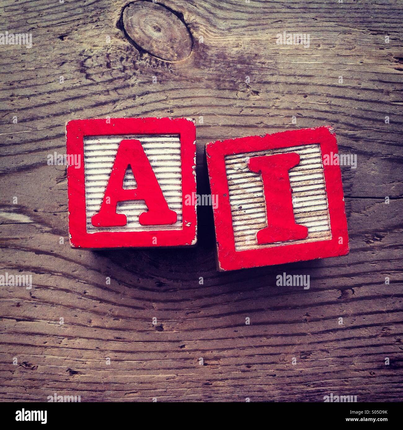 It's a photo of few wood blocks toys with alphabet letters on them combined together to create an acronym AI for Artificial Intelligence - Smartphone Captured Stock Image