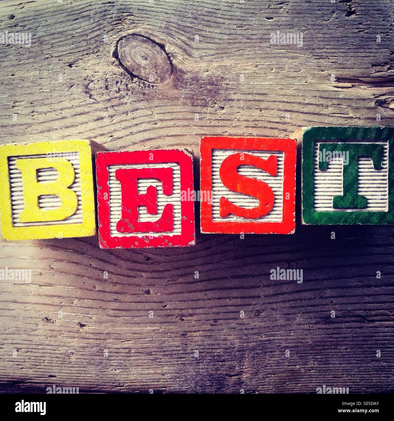 It's a photo of few wood blocks toys with alphabet letters on them combined together to create the word BEST - Smartphone Captured Stock Image