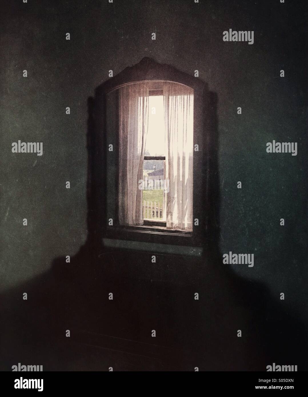 Old fashioned mirror reflecting rural setting through a window. - Smartphone Captured Stock Image