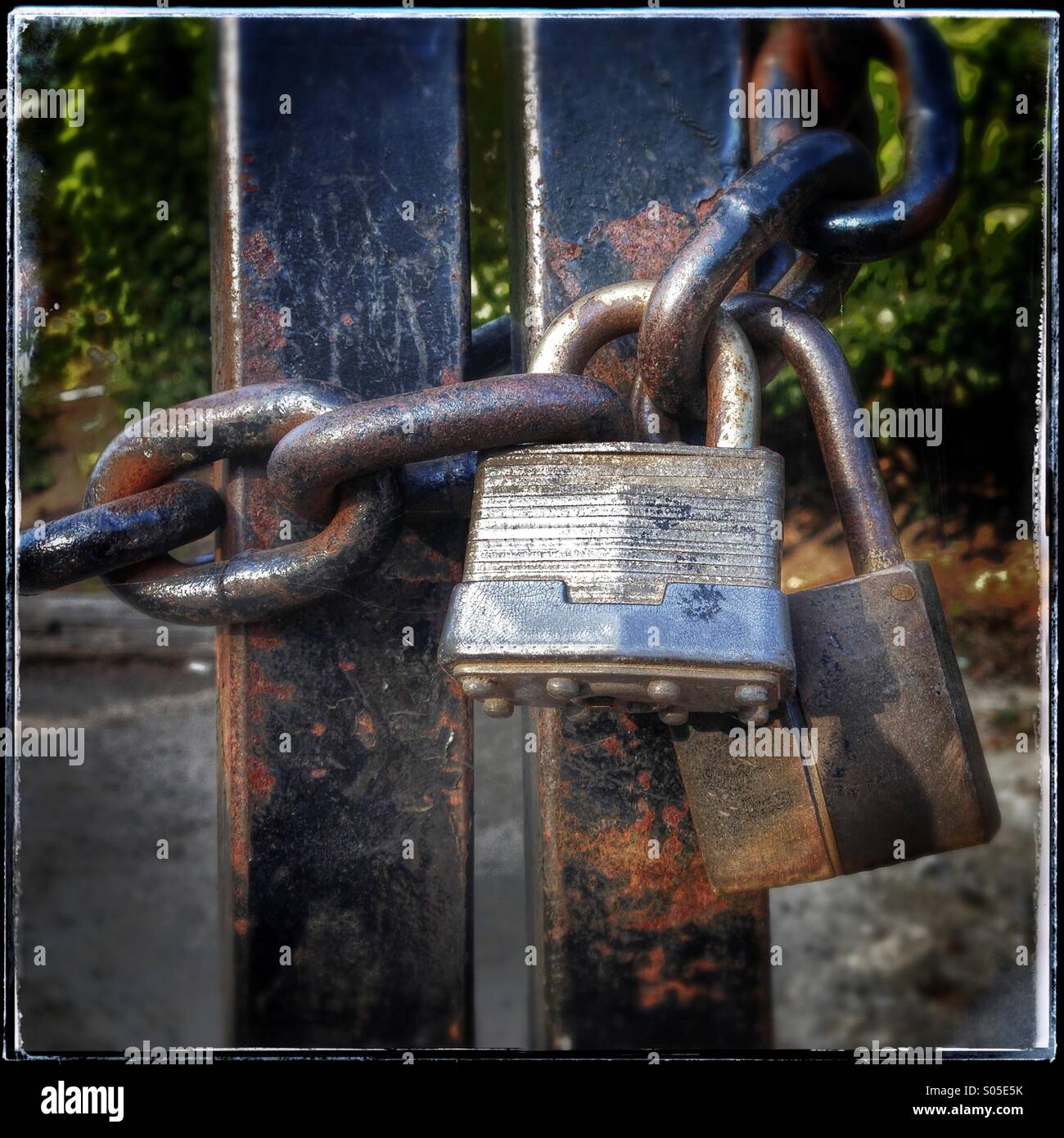 Two Old Rusty Padlocks And Metal Chain Securely Lock A Gate Stock Photo ...