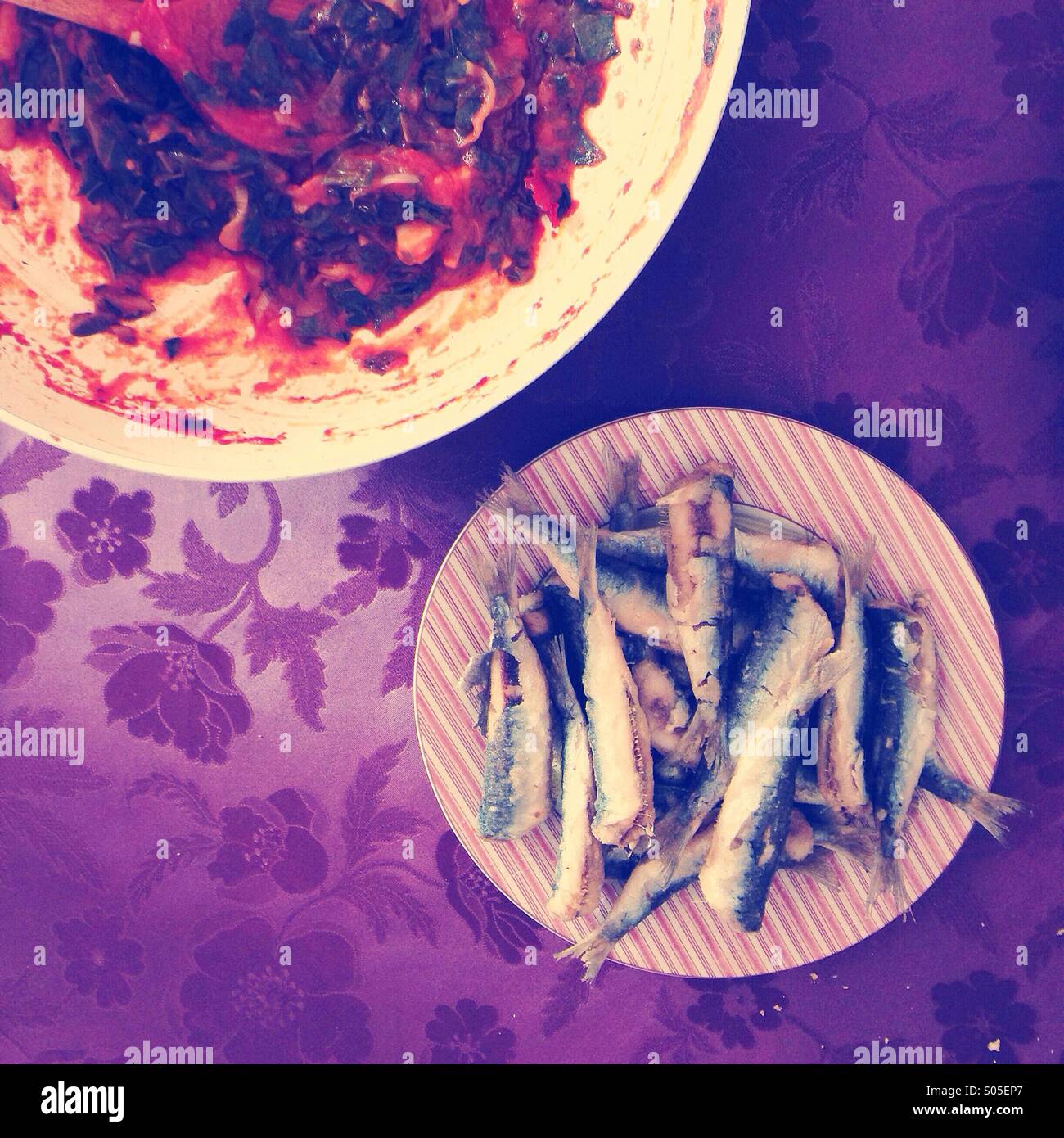 Fried sardines with cabbage tomato sauce on table Stock Photo Alamy