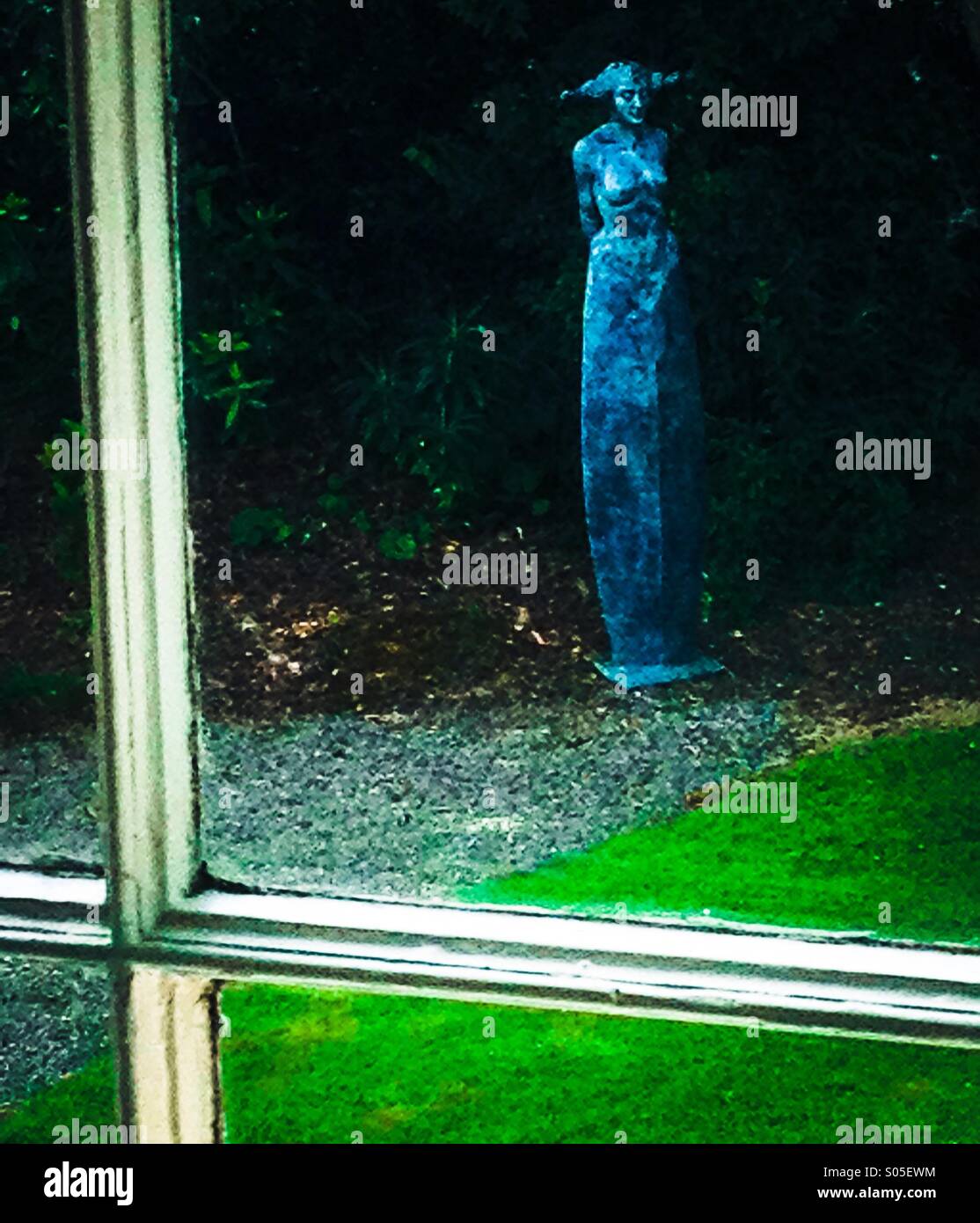 Statue through a window Stock Photo - Alamy