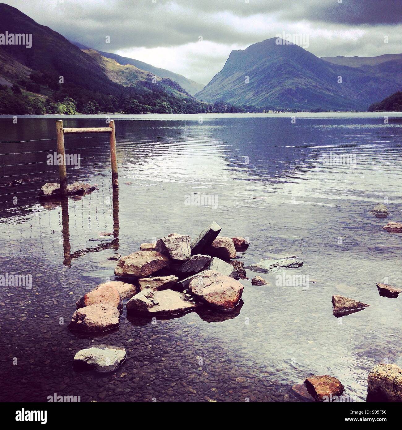 Rocks and a fence in Buttermere in the Lake District - Smartphone Captured Stock Image