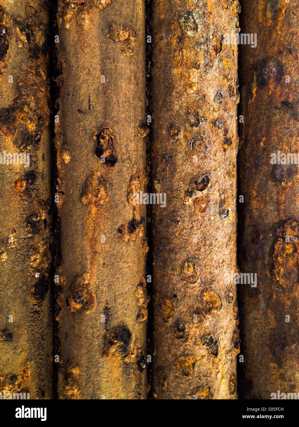 Rows of rusted pipes from a water well. - Smartphone Captured Stock Image