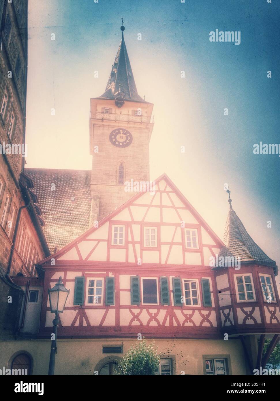 German gothic  church Stiftskirche in Öhringen and medieval half timbered house. Stylish retro design postprocessing - Smartphone Captured Stock Image