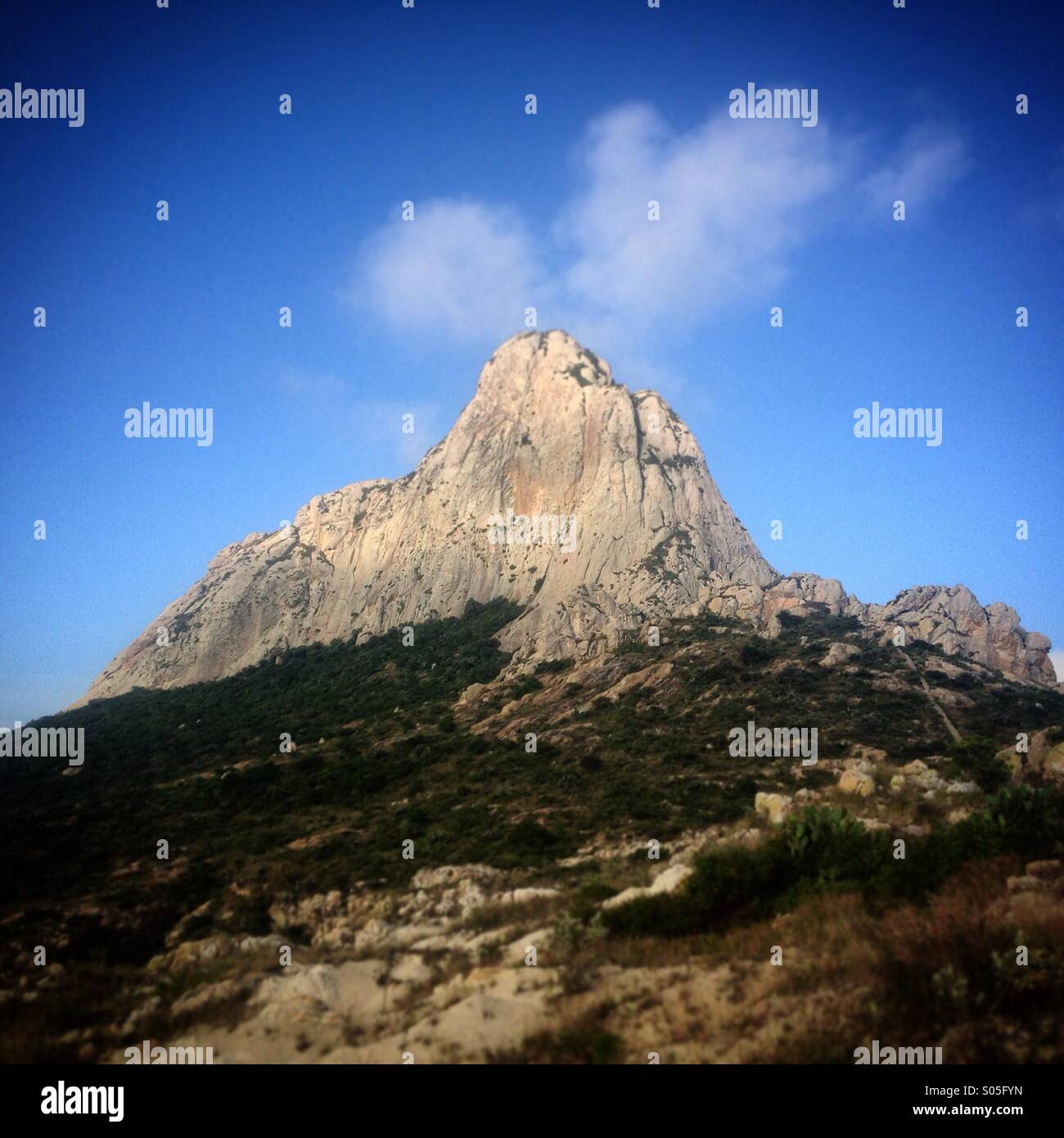 The Peña de Bernal in San Sebastian Bernal village, Queretaro state, Mexico. The Peña of Bernal is a monolith, a mountain formed of a single rock. - Smartphone Captured Stock Image