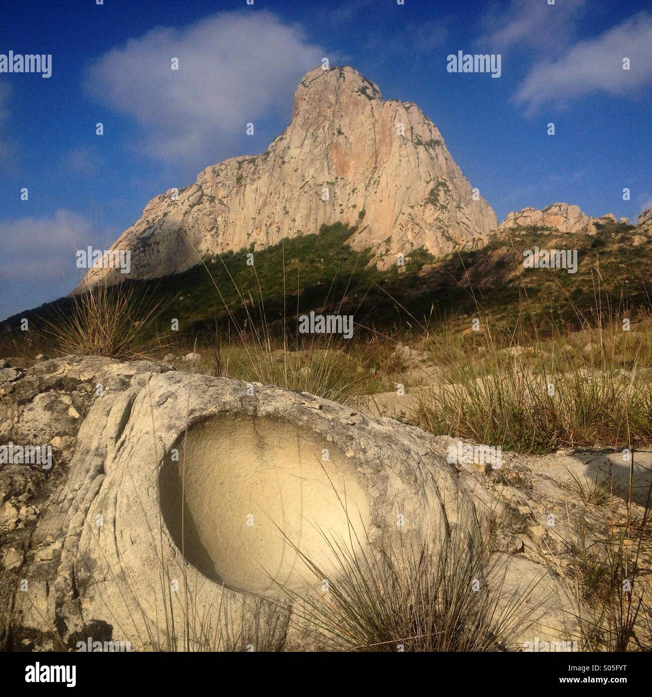 A sphere caused by a dinosaur egg is seen in front of the Peña de Bernal, Queretaro state, Mexico - Smartphone Captured Stock Image
