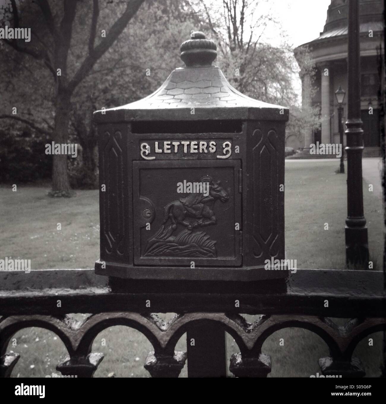Old fashioned letterbox on an iron fence. - Smartphone Captured Stock Image